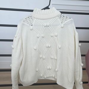 Creamy turtleneck sweater with the cutest puff balls.